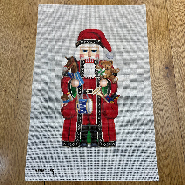 Santa and Pockets of Toys Nutcracker Needlepoint Canvas – 13 Mesh | Susan Roberts