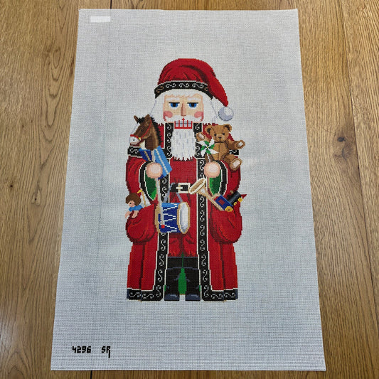 Santa and Pockets of Toys Nutcracker Needlepoint Canvas – 13 Mesh | Susan Roberts